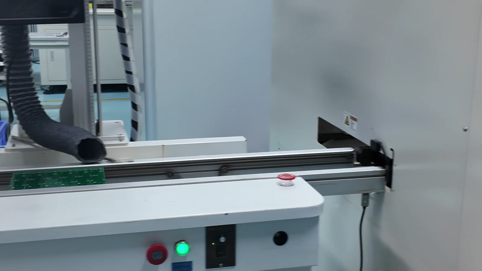 Production machine controls and conveyor area recorded during a portable-light equipment handoff review