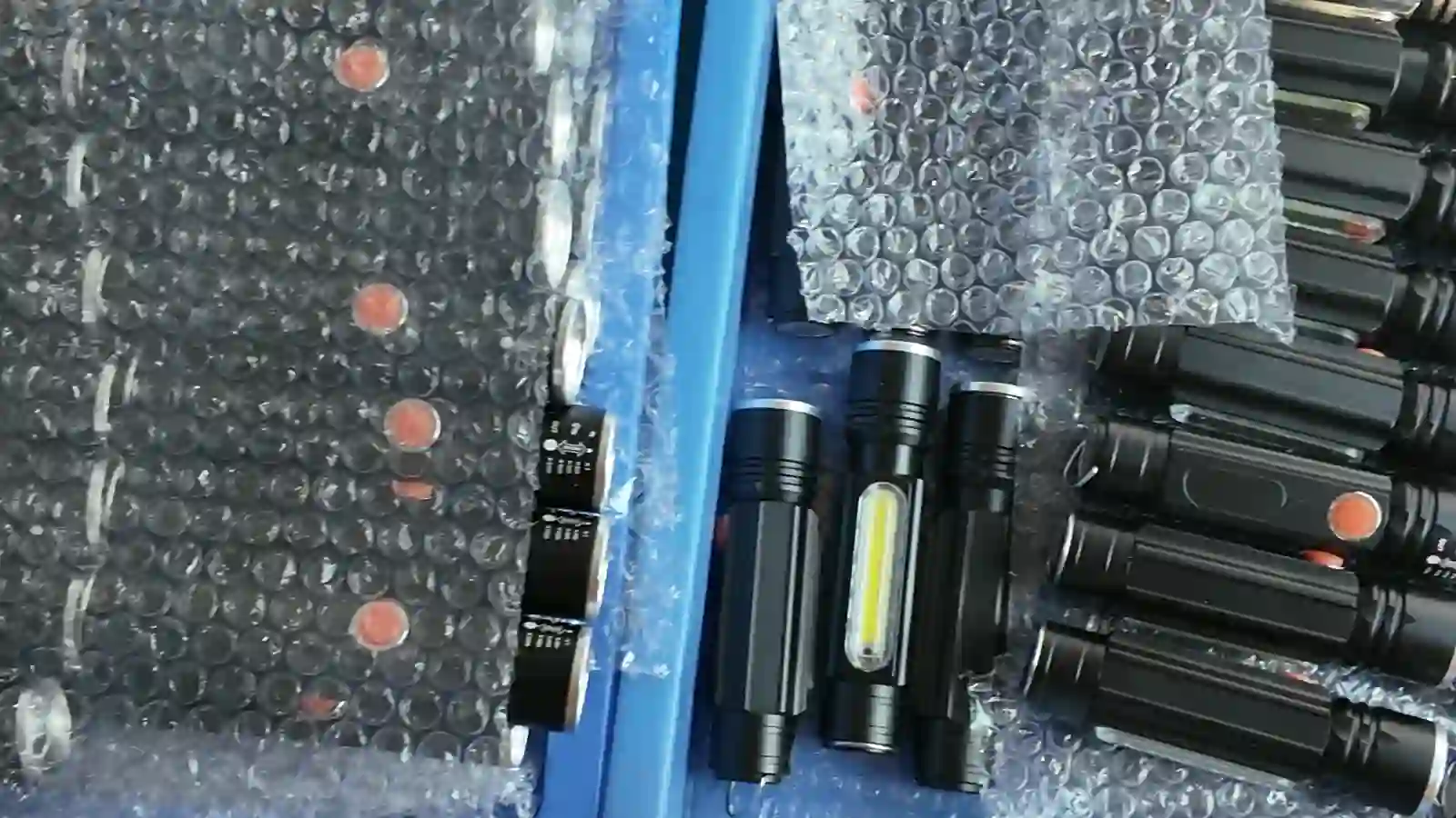 Portable lights and retail boxes separated in trays during a quantity and variant reconciliation review