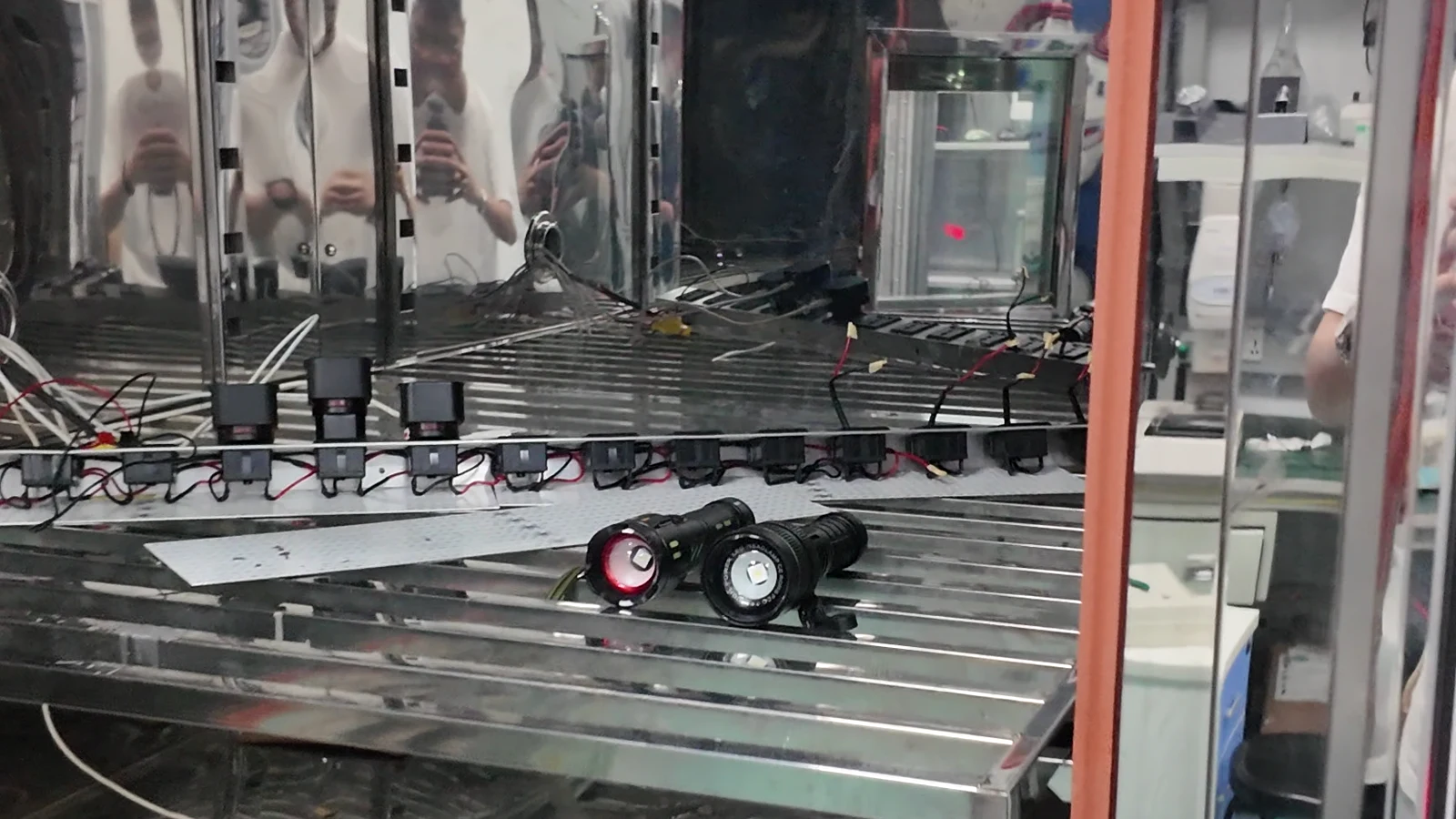 Portable work lights and wired test samples inside a temperature and humidity test chamber
